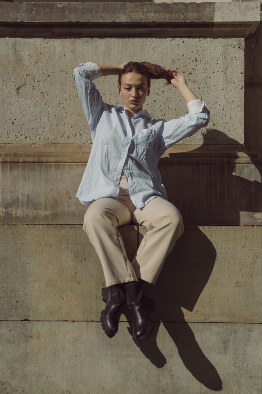 editorial portrait of female model posing on old building in Amsterdam