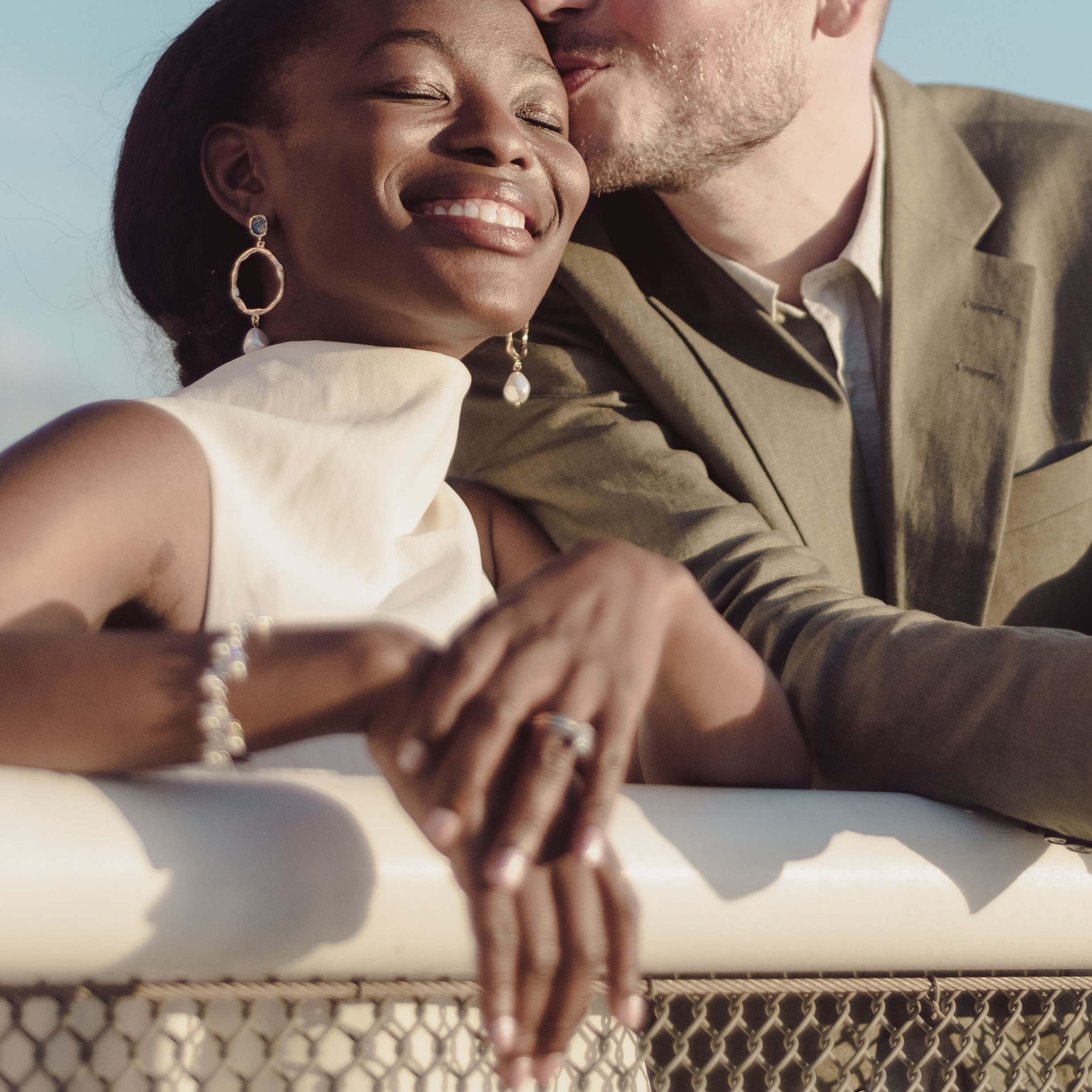 Married couple portrait smiling at golden hour