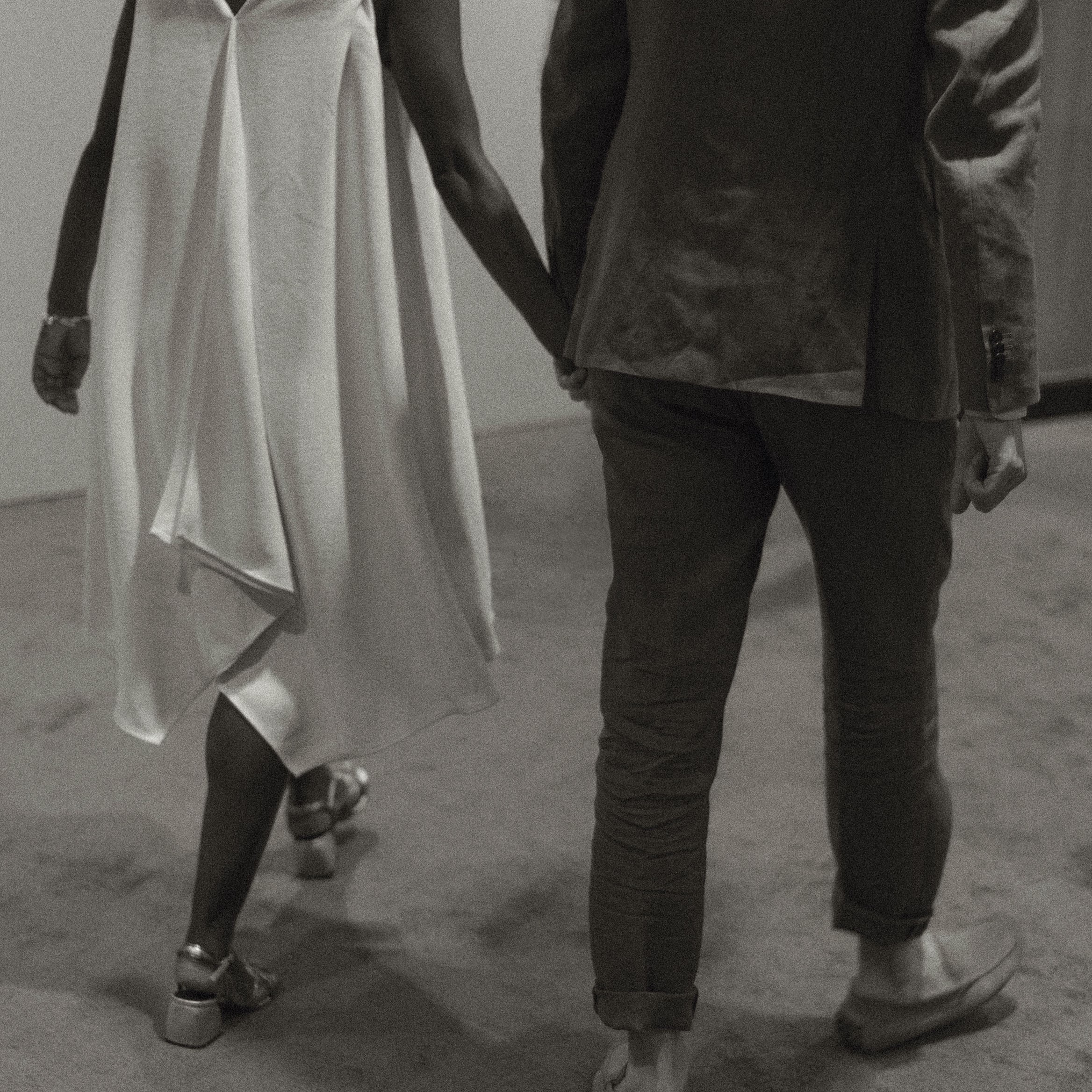 Photo of married couple walking hand in hand